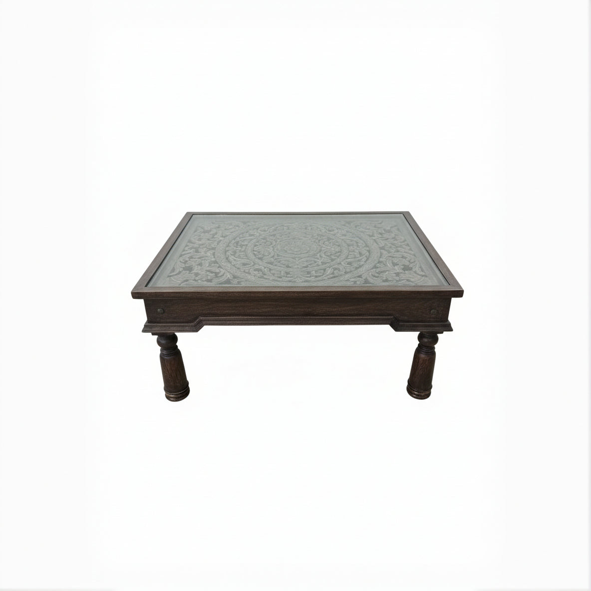 Handcrafted wooden table with intricate carved floral pattern and turned legs