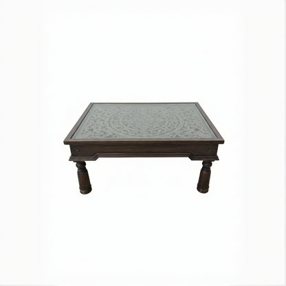 Handcrafted wooden table with intricate carved floral pattern and turned legs