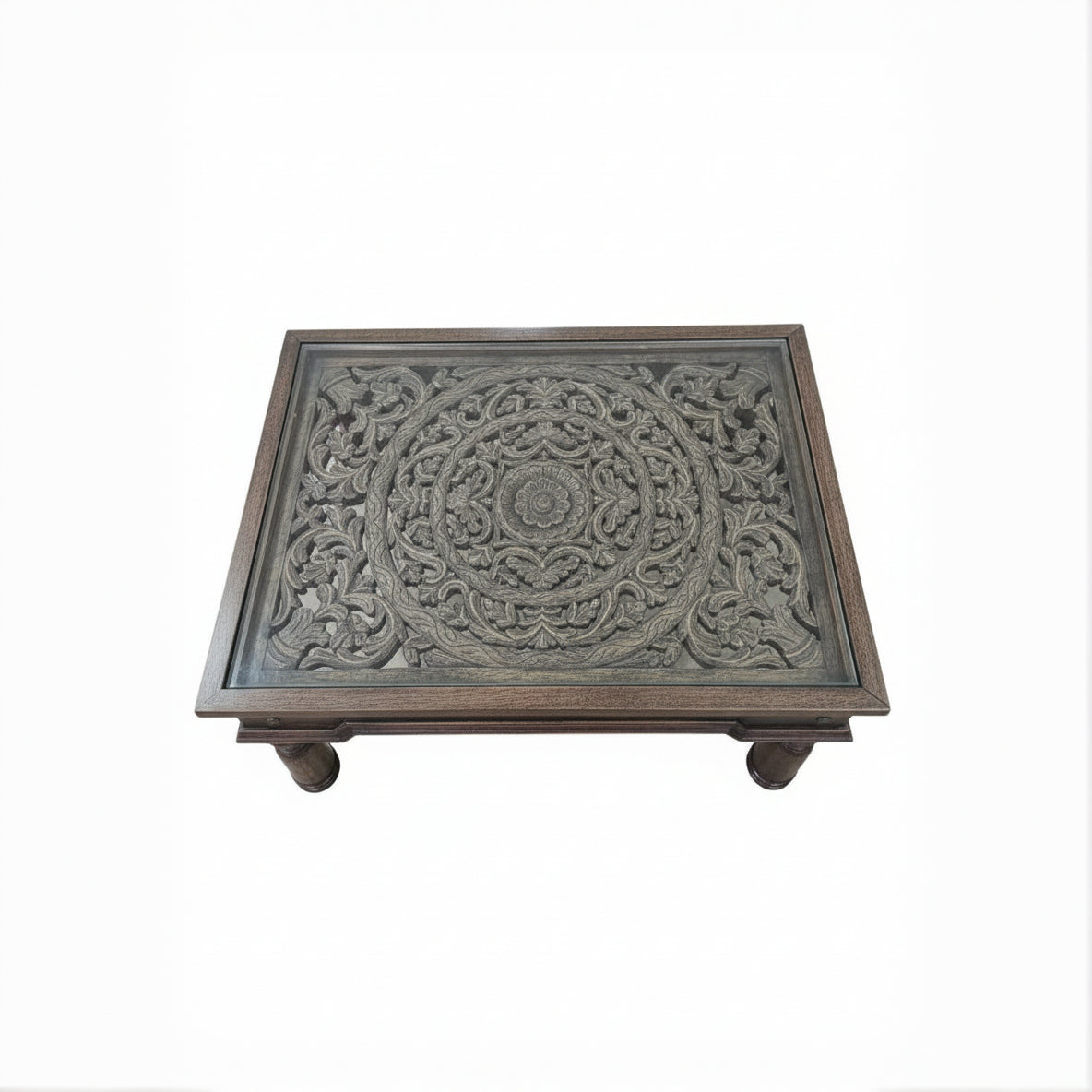 Handcrafted wooden table with intricate floral carvings, tribal decor style