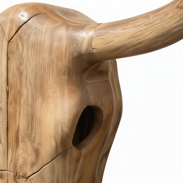 Handcrafted wooden bull skull sculpture with natural finish and carved details