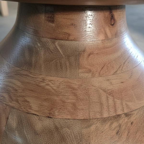 Close-up of handcrafted wooden vase with natural grain and smooth polished finish