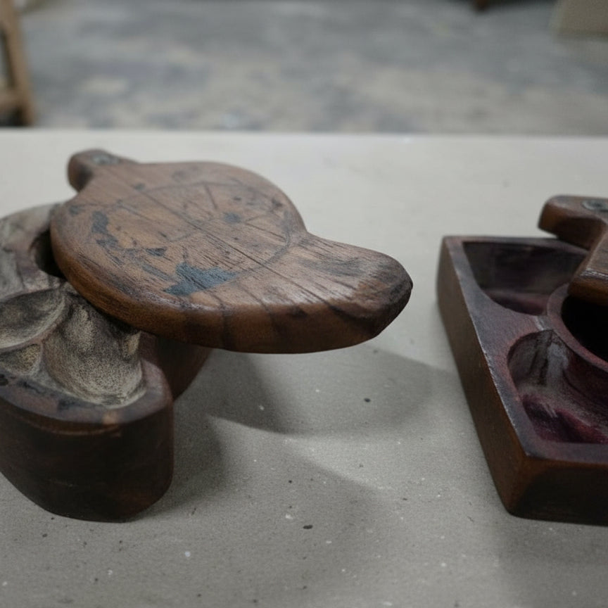 Handcrafted wooden tribal jewelry box with intricate carved design on a table