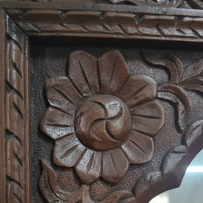 Hand-carved wooden floral frame with intricate tribal handicraft details