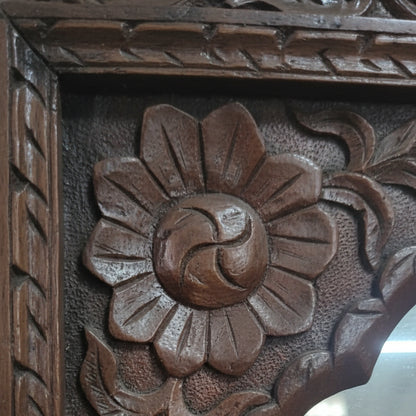 Hand-carved wooden floral frame with intricate tribal handicraft details