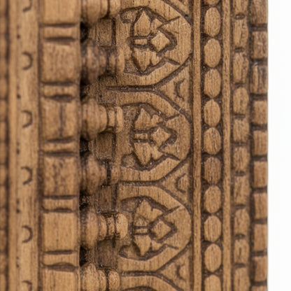 Close-up of intricate carved wooden tribal handicraft with geometric patterns
