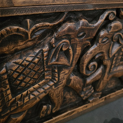 Hand-carved wooden panel with tribal elephant motifs and intricate detailing
