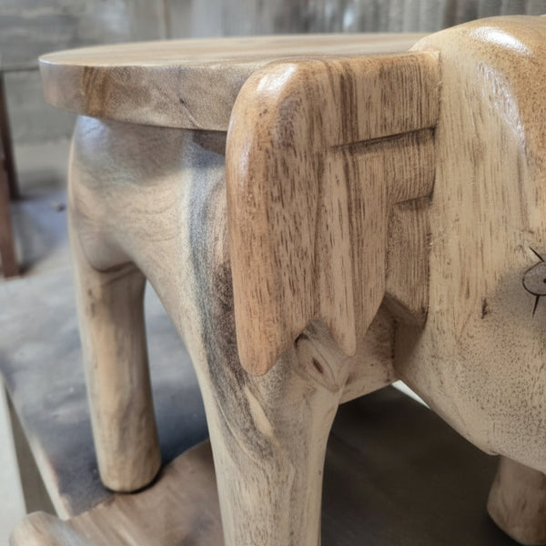 Handcrafted wooden elephant stool with natural finish and carved details