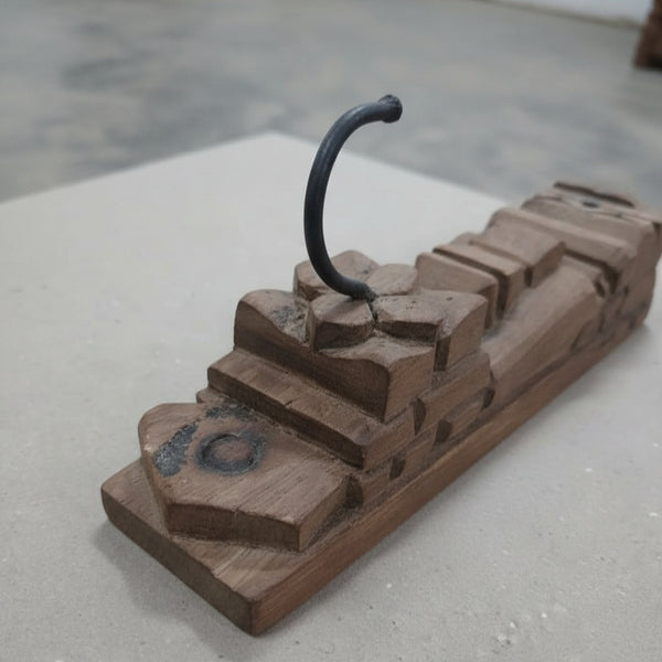 Handcrafted wooden wall hook with tribal geometric carvings, rustic decor accent