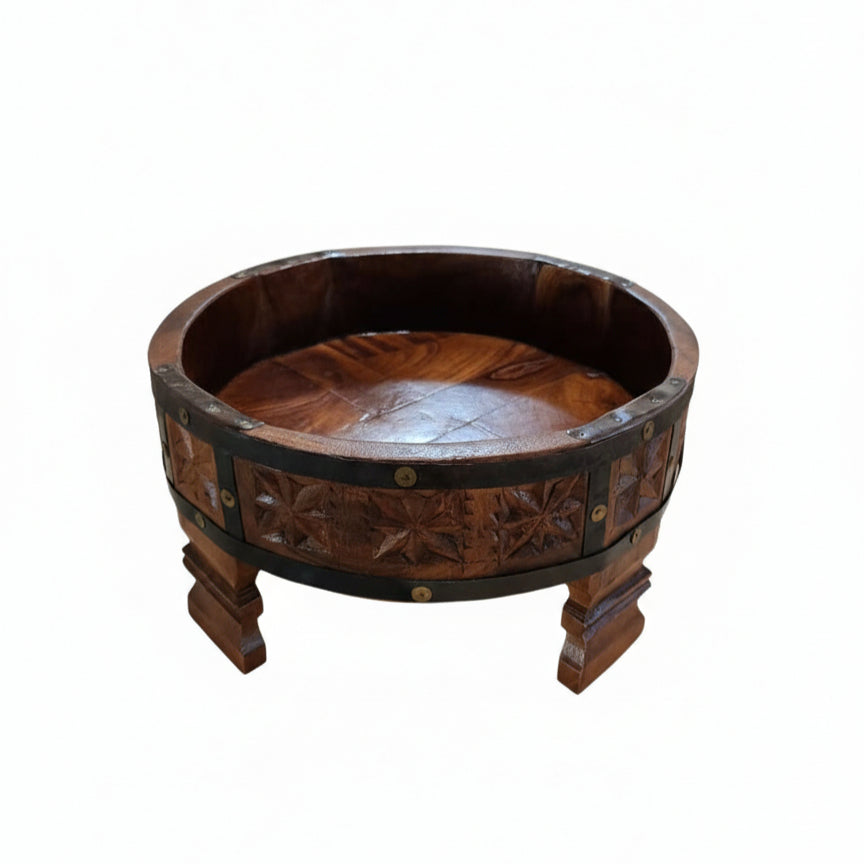 A handcrafted Ahaar Wooden Fruit Bowl featuring intricate carved floral patterns and sturdy legs, perfect for rustic wooden decor and tribal handicrafts display.