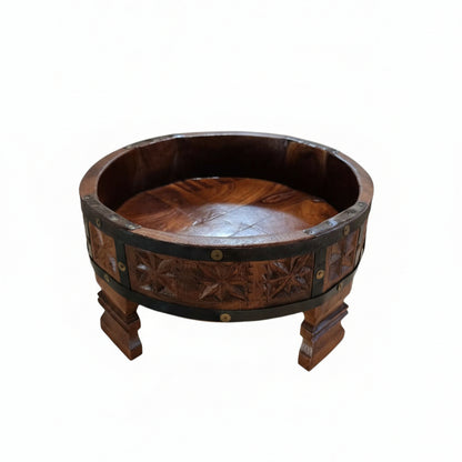 A handcrafted Ahaar Wooden Fruit Bowl featuring intricate carved floral patterns and sturdy legs, perfect for rustic wooden decor and tribal handicrafts display.