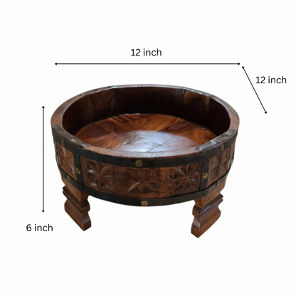 A handcrafted Ahaar Wooden Fruit Bowl featuring intricate carved floral patterns and sturdy legs, perfect for rustic wooden decor and tribal handicrafts display.