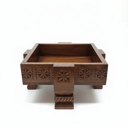 A handcrafted Ahaar Wooden Fruit Bowl featuring intricate tribal handicraft carvings on its dark wooden surface, designed as a decorative and functional piece.