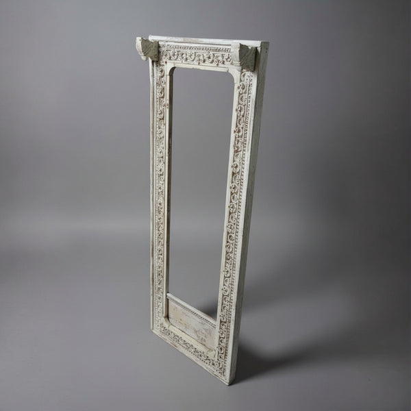Ashva Wooden Mirror Frame in white with intricate carved wooden details, showcasing elegant handicraft decor ideal for adding a rustic, artistic touch to any space.
