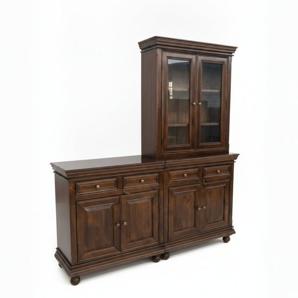Elegant wooden display cabinet with rich dark finish, featuring glass-paneled upper doors and multiple drawers and cupboards, showcasing handcrafted tribal decor style.