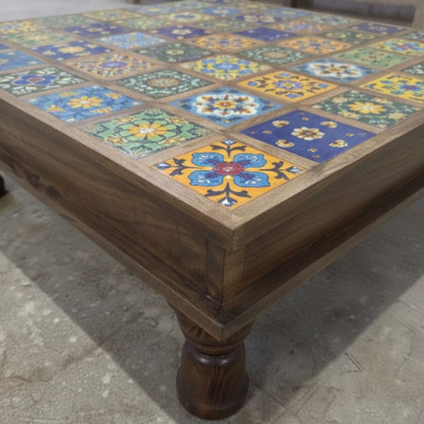 Bajot Chowki Floor Pedestal featuring a wooden frame with colorful, intricate tile patterns on top, showcasing traditional tribal handicrafts decor.