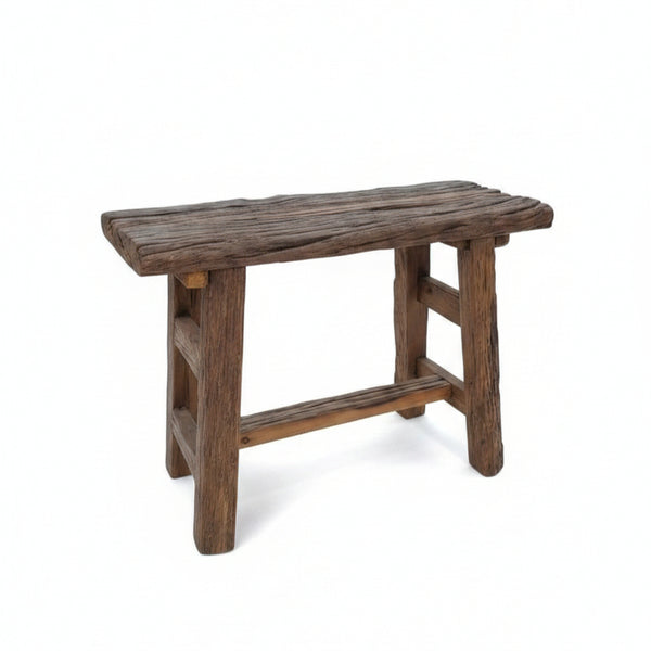 Rustic handcrafted wooden stool with a natural finish, featuring sturdy solid wood construction and a textured surface, ideal for tribal decor and functional seating.