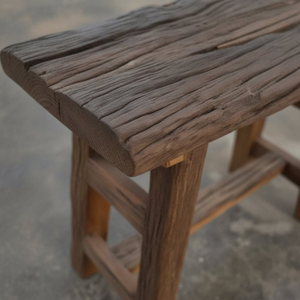 Close-up of a handcrafted wooden Chaupal Rustic Stool showcasing its textured, natural wood grain and sturdy construction, perfect for rustic decor and tribal handicrafts.