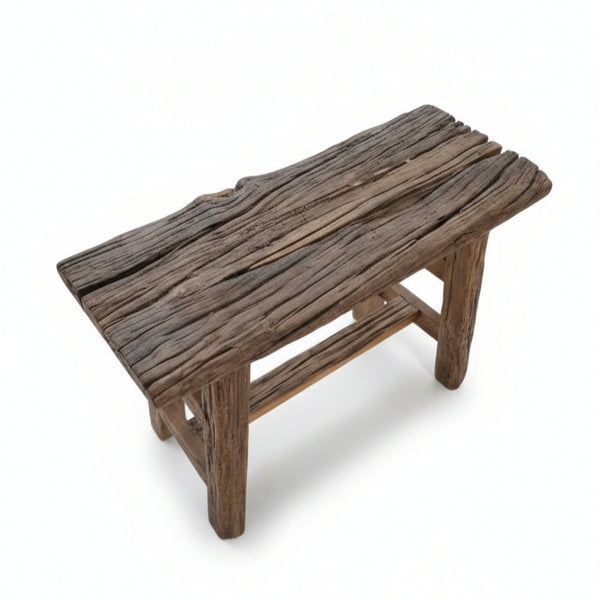 Rustic handcrafted wooden stool with a natural textured finish, showcasing authentic tribal design and solid wood construction, perfect for decor and functional use.