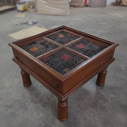 Square wooden side table with four intricately carved tribal mosaic panels, showcasing handcrafted artisan decor in rich dark and earthy tones.