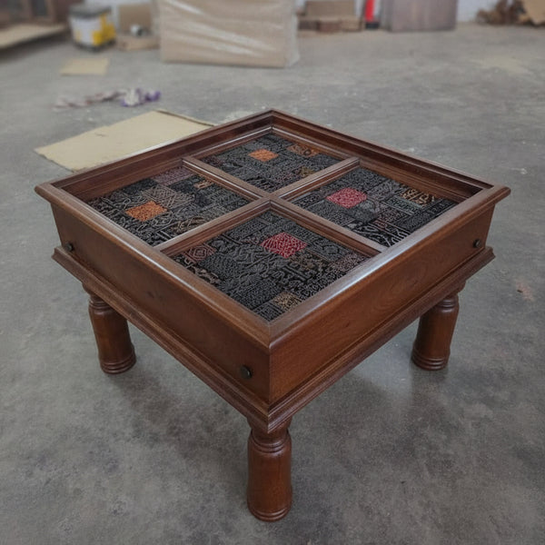 Square wooden side table with four intricately carved tribal mosaic panels, showcasing handcrafted artisan decor in rich dark and earthy tones.