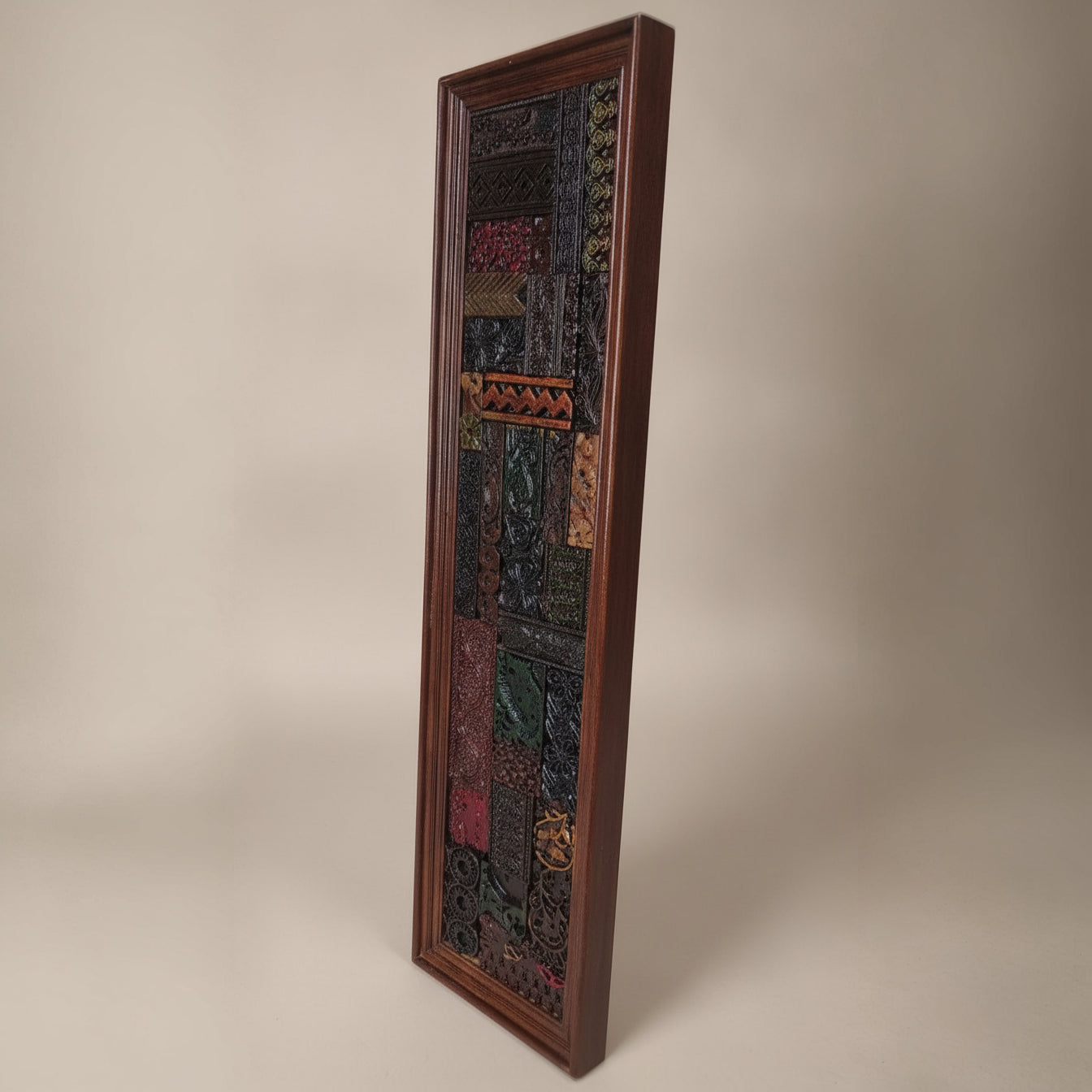 Tall rectangular wooden mosaic wall art featuring intricate tribal patterns and rich earthy tones, showcasing handcrafted detailed decor with a rustic appeal.