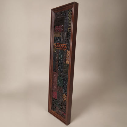 Tall rectangular wooden mosaic wall art featuring intricate tribal patterns and rich earthy tones, showcasing handcrafted detailed decor with a rustic appeal.