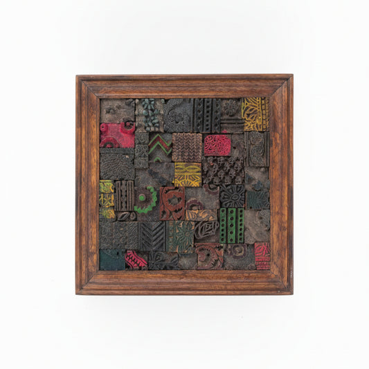 Square wooden mosaic wall art featuring handcrafted tribal-inspired blocks in various colors and patterns within a rich wooden frame, perfect for decorative home accents.