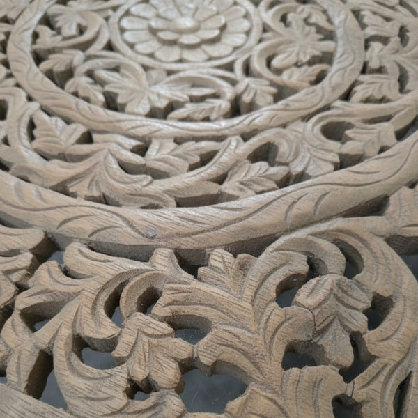 Handcrafted wooden panel with intricate floral and leaf carvings