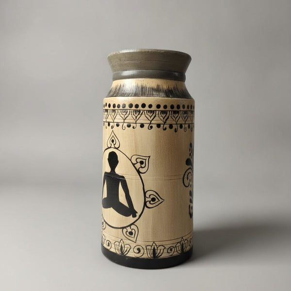 Hand-painted wooden pot featuring a tribal-style silhouette of a meditating figure, decorated with intricate black patterns on a natural wood finish.