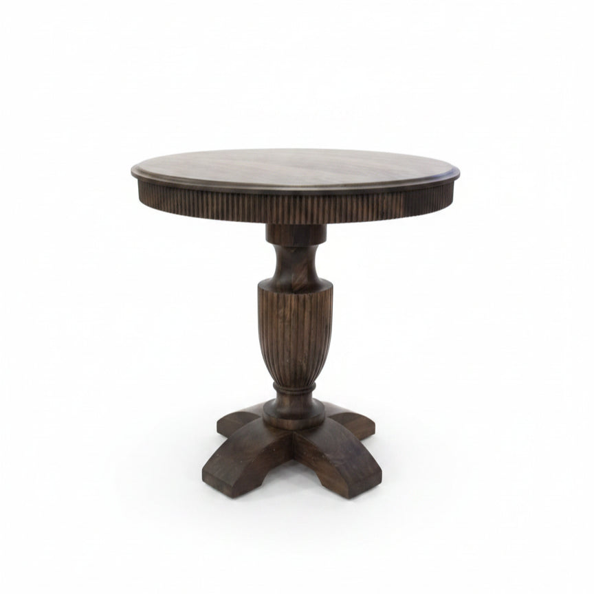 Round wooden pedestal table with handcrafted tribal-inspired details, featuring a sturdy central column and four curved legs, perfect for unique home decor.