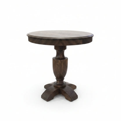 Round wooden pedestal table with handcrafted tribal-inspired details, featuring a sturdy central column and four curved legs, perfect for unique home decor.