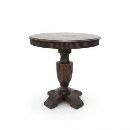 Round wooden pedestal table with handcrafted tribal-inspired details, featuring a sturdy central column and four curved legs, perfect for unique home decor.