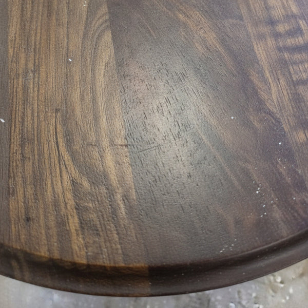 Close-up of the handcrafted wooden surface of the Diwan Round Pedestal Table showcasing natural grain patterns and smooth finish, ideal for rustic decor.