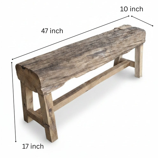 Rustic wooden bench handcrafted with a solid timber slab seat, showcasing natural grain and texture, supported by sturdy wooden legs for authentic tribal handicraft decor.