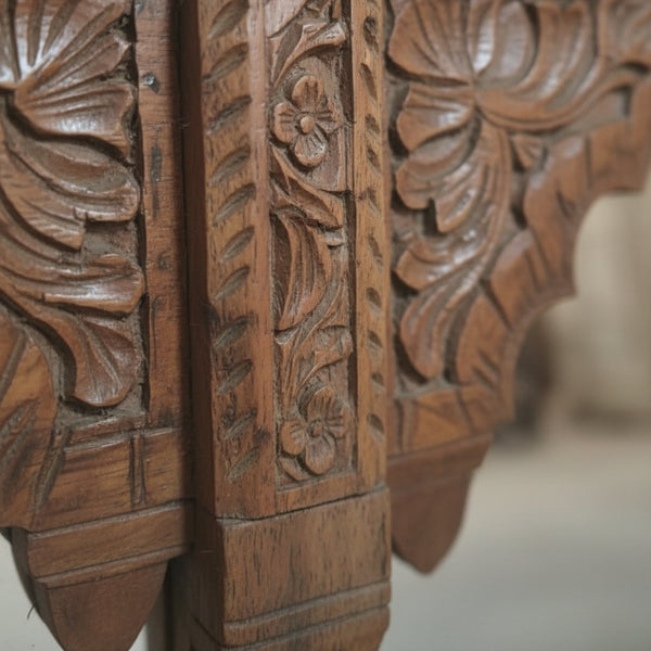 Hand-carved wooden furniture with detailed floral and leaf design, tribal handicraft