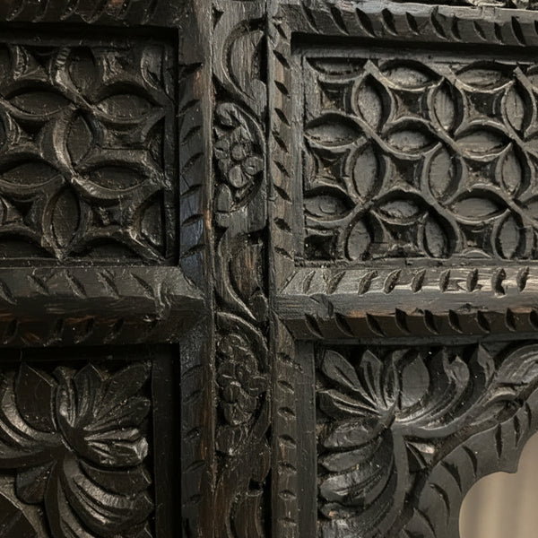 Close-up of the Jharokha Wall Hanging, featuring dark wood with intricate hand-carved floral and geometric patterns—showcasing deep grooves and remarkable craftsmanship, making it an exquisite piece of decor.