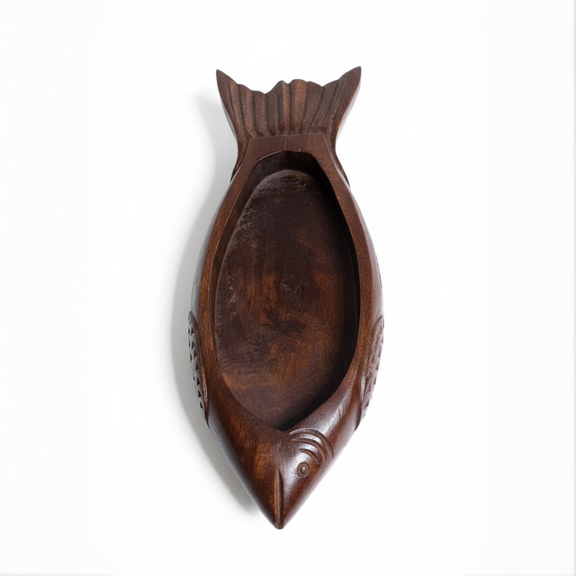 Handcrafted wooden organizer tray in a fish shape with smooth finish and tribal-inspired detailing, ideal for unique decor and functional storage.