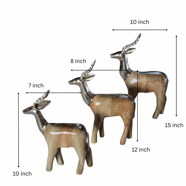 The Mriga Trio Wooden Decor features three polished wooden deer figurines with metallic silver antlers, arranged together and facing left. Combining natural wood with metallic accents, this set adds a charming touch to any decor.
