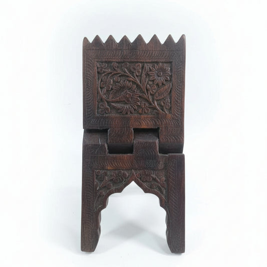 Rehal Wooden Carved Bookstand made of dark wood featuring intricate floral hand-carved designs, showcasing traditional handicraft decor for holding books elegantly.
