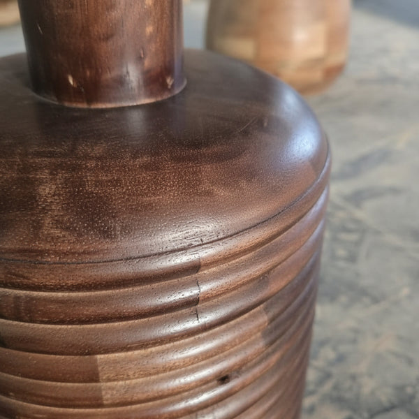 Close-up of handcrafted wooden vase with textured ridges, tribal home decor