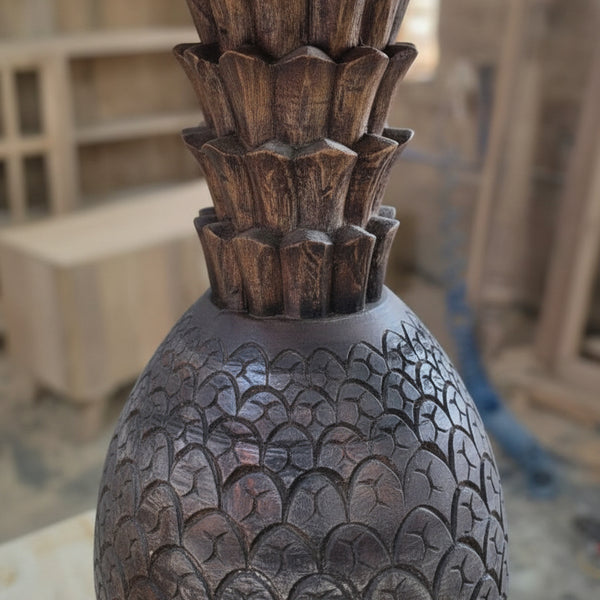 Close-up of a handcrafted wooden piece featuring detailed tribal carvings and textured patterns, showcasing traditional artisanal decor craftsmanship.