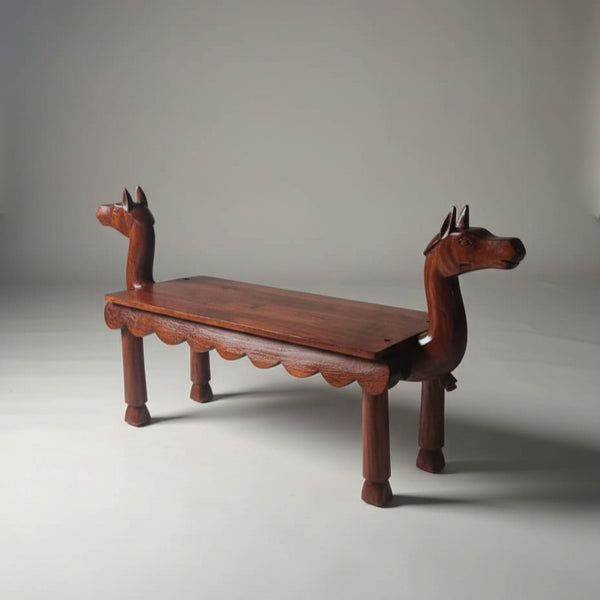 Vahana Carved Wooden Bench featuring detailed animal head carvings on each end, handcrafted from rich wood for unique decor and tribal handicraft appeal.