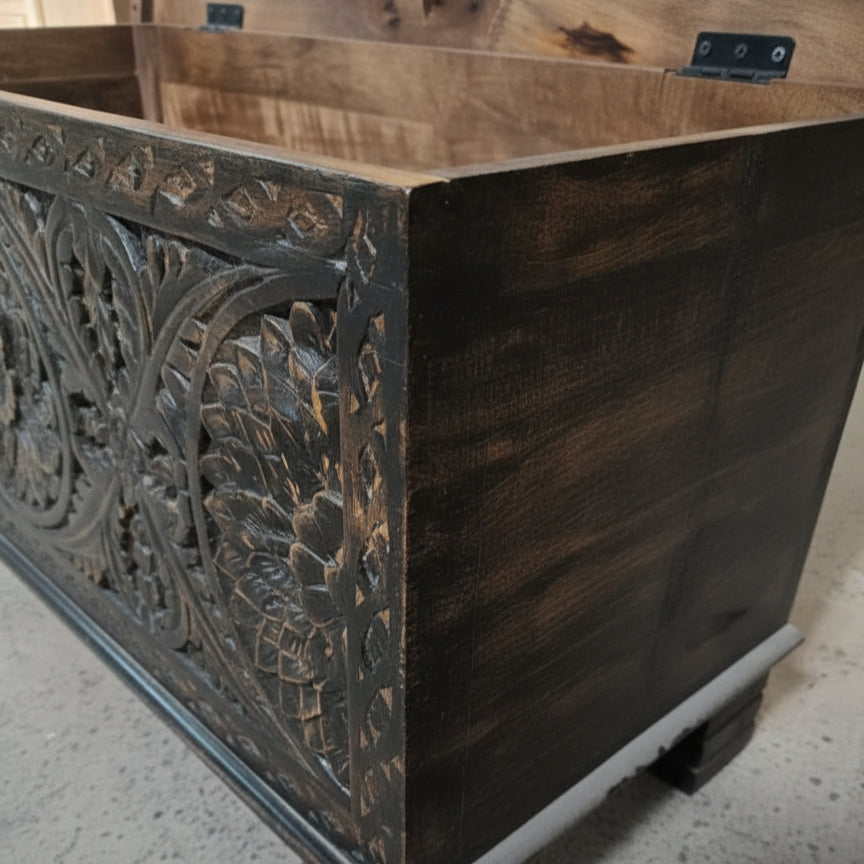 Handcrafted wooden storage chest with intricate floral carvings on dark stained wood
