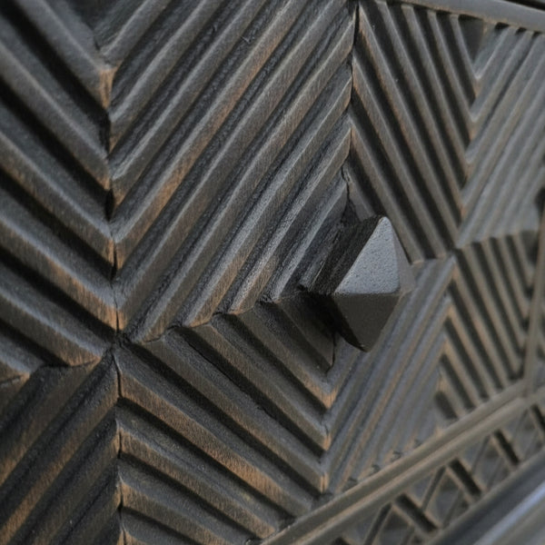Close-up of the textured geometric wooden pattern and handle detail on the Yantra Storage Coffee Unit, showcasing handcrafted decor with a tribal handicraft style.
